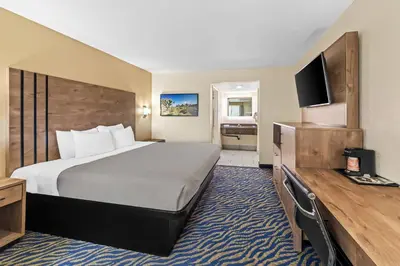 a hotel room with a large bed and a television at Quality Inn & Suites in Hesperia