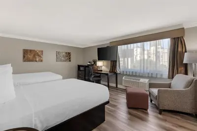 a hotel room with a bed and a desk at Best Western Plus LA Mid-Town Hotel in Los Angeles