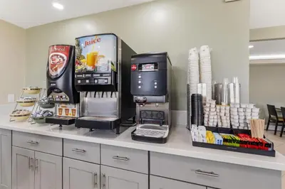 a counter with a drink dispenser and a coffee machine at Best Western Plus LA Mid-Town Hotel in Los Angeles