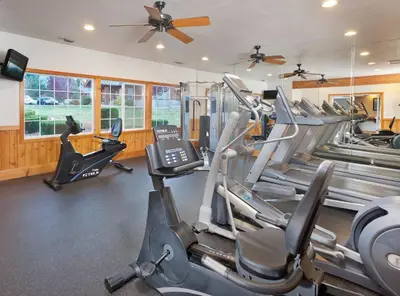 a gym with several treadmills and elliptical machines at WorldMark Big Bear Lake in Big Bear Lake