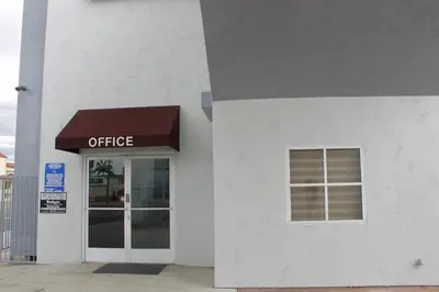 a building with an office sign on the side of it at Crescent Inn in Wilmington