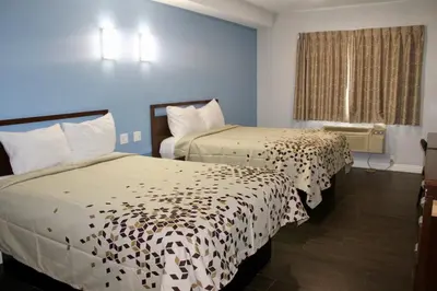 a hotel room with two beds and a window at Crescent Inn in Wilmington