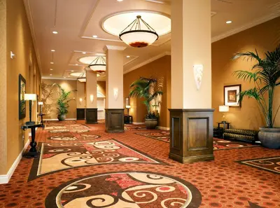 a hotel lobby with a fireplace and a large rug at DoubleTree Suites By Hilton Anaheim Resort/Convention Center in Anaheim