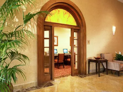 an arched entryway to a room with a table and a desk at DoubleTree Suites By Hilton Anaheim Resort/Convention Center in Anaheim