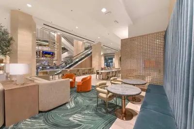 a lobby of a hotel with tables and chairs at Hilton Anaheim in Anaheim