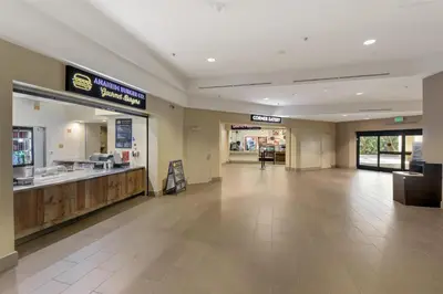 a lobby of a shopping mall with a food counter at Hilton Anaheim in Anaheim