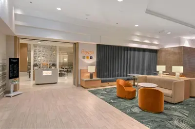 a lobby with couches and chairs in a hotel at Hilton Anaheim in Anaheim