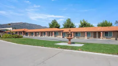 an empty street in front of a building at Oak Park Motel in Monrovia