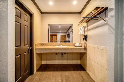 a bathroom with a sink and a mirror at Oak Park Motel in Monrovia