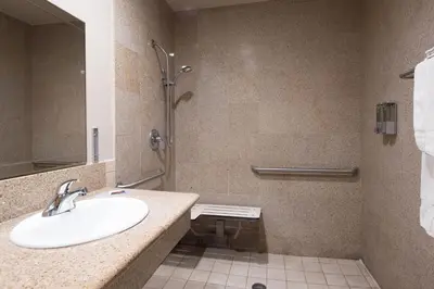 a bathroom with a sink and a shower at Oak Park Motel in Monrovia
