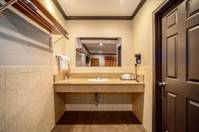 a bathroom with a sink and a mirror at Oak Park Motel in Monrovia