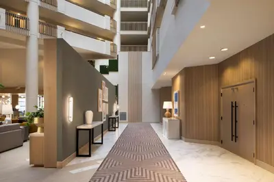 a hallway of a hotel lobby with a carpet at Hilton Santa Monica in Los Angeles