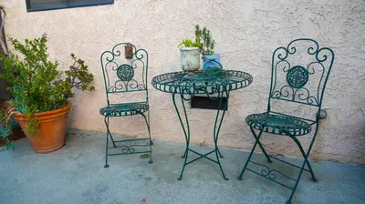 two chairs and a table and a table and chairs with plants at Cozy private Guest House in Los Angeles