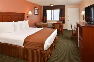 a hotel room with a bed and a television at Americas Best Value Inn & Suites-East Bakersfield in Bakersfield