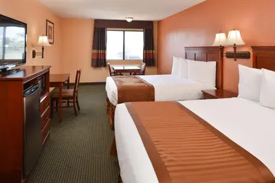 a hotel room with two beds and a television at Americas Best Value Inn & Suites-East Bakersfield in Bakersfield