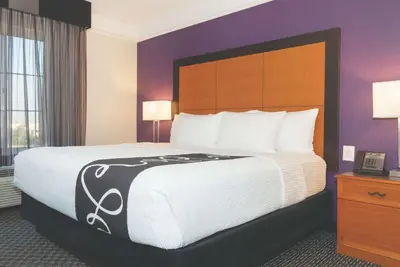 a bed in a hotel room with a large bed at La Quinta Inn & Suites by Wyndham Ontario Airport in Ontario