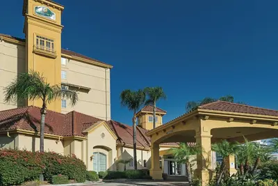 a building with a clock tower and a building with trees at La Quinta Inn & Suites by Wyndham Ontario Airport in Ontario