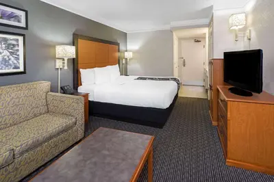 a hotel room with a bed and a couch at La Quinta by Wyndham Buena Park in La Palma