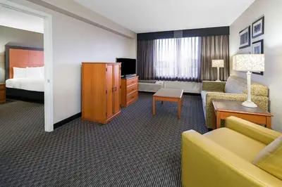 a hotel room with a couch and a bed at La Quinta by Wyndham Buena Park in La Palma