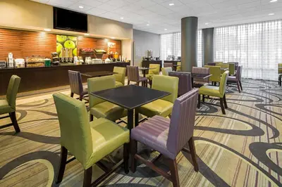 a waiting room with tables and chairs in a restaurant at La Quinta by Wyndham Buena Park in La Palma