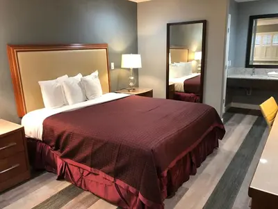 a hotel room with a large bed and a bathroom at Del Mar Motel in Rosemead