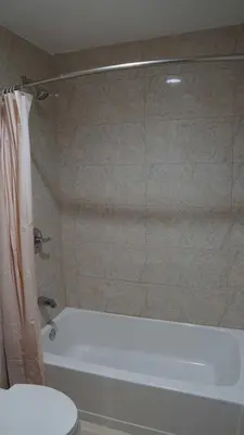 a bathroom with a shower and a tub and a toilet at Del Mar Motel in Rosemead
