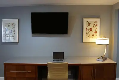 a desk with a laptop and a lamp on a wall at Del Mar Motel in Rosemead
