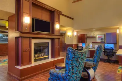 a hotel room with a fireplace and a tv at Hampton Inn & Suites Ontario in Ontario