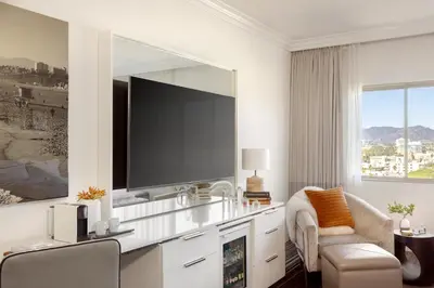 a living room with a large flat screen tv at Huntley Santa Monica Beach in Los Angeles