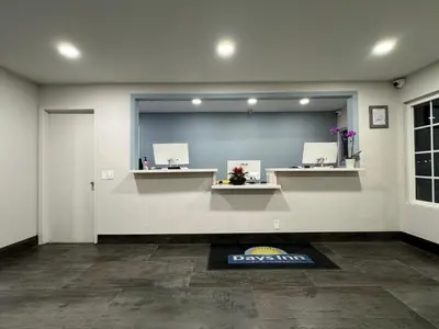 a room with a waiting room with a large mirror at Days-Inn by Wyndham Bakersfield in Bakersfield