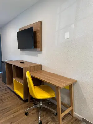 an office with a desk and a yellow chair at Days-Inn by Wyndham Bakersfield in Bakersfield