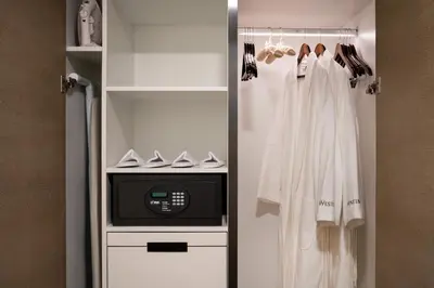 a walk in closet with white clothes and a microwave at The Westin Anaheim Resort in Anaheim