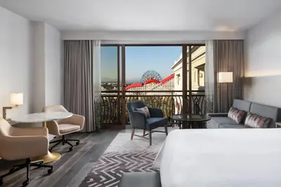 a hotel room with a bed and a table and chairs at The Westin Anaheim Resort in Anaheim