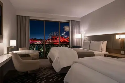 a hotel room with two beds and a large window at The Westin Anaheim Resort in Anaheim