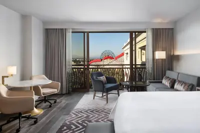a hotel room with a bed and a table and chairs at The Westin Anaheim Resort in Anaheim