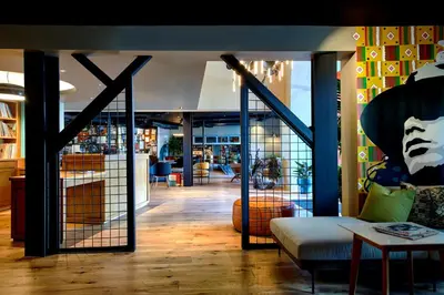 a living room with a couch and a table at Hotel Ziggy On Sunset in Los Angeles