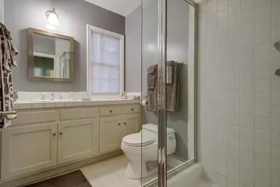 a bathroom with a toilet and a sink and a mirror at A Touch of Cape Cod in West Hollywood in Los Angeles