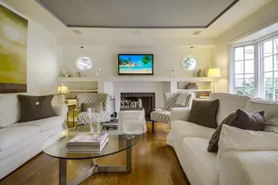 a living room with a couch and a table at A Touch of Cape Cod in West Hollywood in Los Angeles