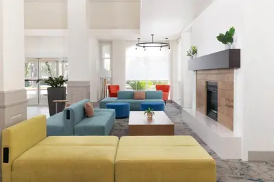 a living room with two couches and a fireplace at Hilton Garden Inn Ontario Rancho Cucamonga in Rancho Cucamonga