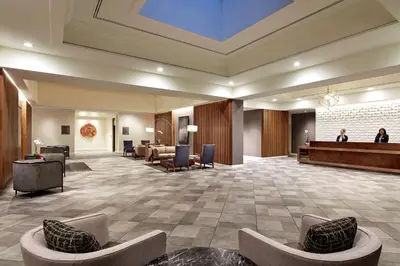 a lobby with couches and a waiting area with a waiting room at Hilton Pasadena in Pasadena