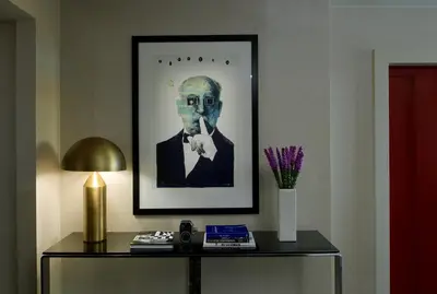 a framed picture of a man on a table with a lamp at Kimpton Hotel Palomar Los Angeles Beverly Hills by IHG in Los Angeles