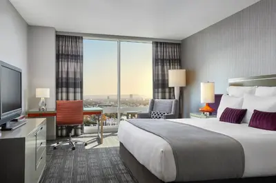 a hotel room with a bed and a large window at Loews Hollywood Hotel in Los Angeles