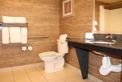 a bathroom with a toilet and a sink at Holiday Inn Express Port Hueneme by IHG in Port Hueneme