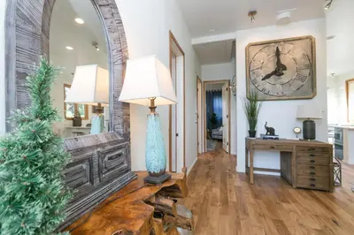 a living room with a christmas tree and a clock at Stunning 2-Bedroom Home near Downtown Culver in Los Angeles