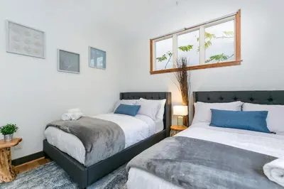 two beds sitting next to each other in a bedroom at Stunning 2-Bedroom Home near Downtown Culver in Los Angeles