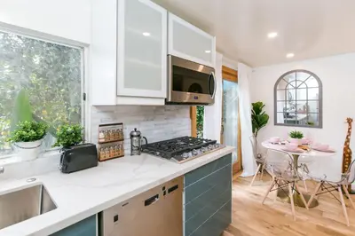 a kitchen with white cabinets and a stove top oven at Charming 1-Bedroom Home near Downtown Culver in Los Angeles
