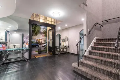 a house with a staircase leading to the front door at Wilshire Crest Hotel in Los Angeles