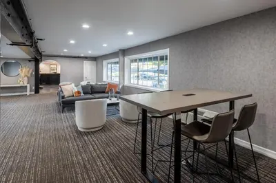 a living room with a table and chairs at Wilshire Crest Hotel in Los Angeles