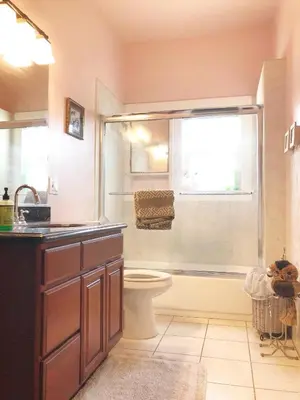 a bathroom with a toilet and a shower with a window at Cozy Suite near City of hope in Duarte