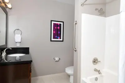 a white bathroom with a sink and a toilet at WorldMark Anaheim in Anaheim